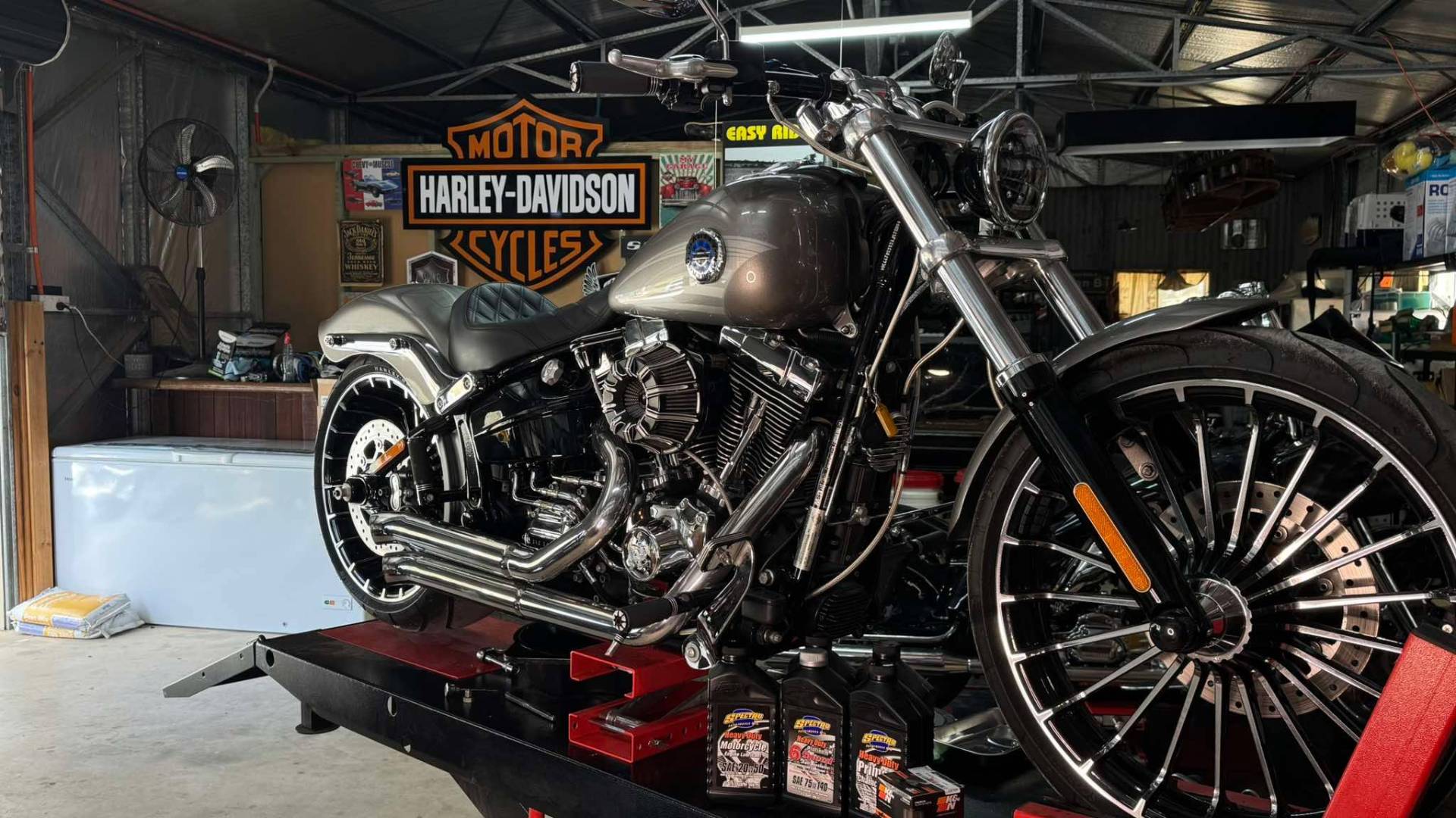 Custom Harley motorcycle in a dark workshop